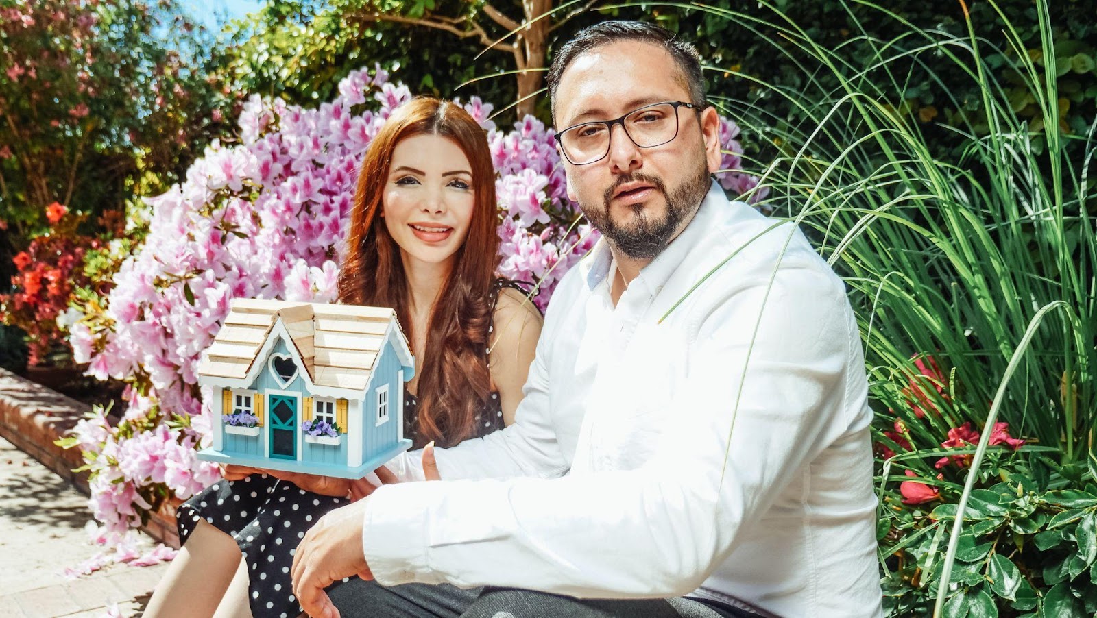 real estate professionals with a model of a house