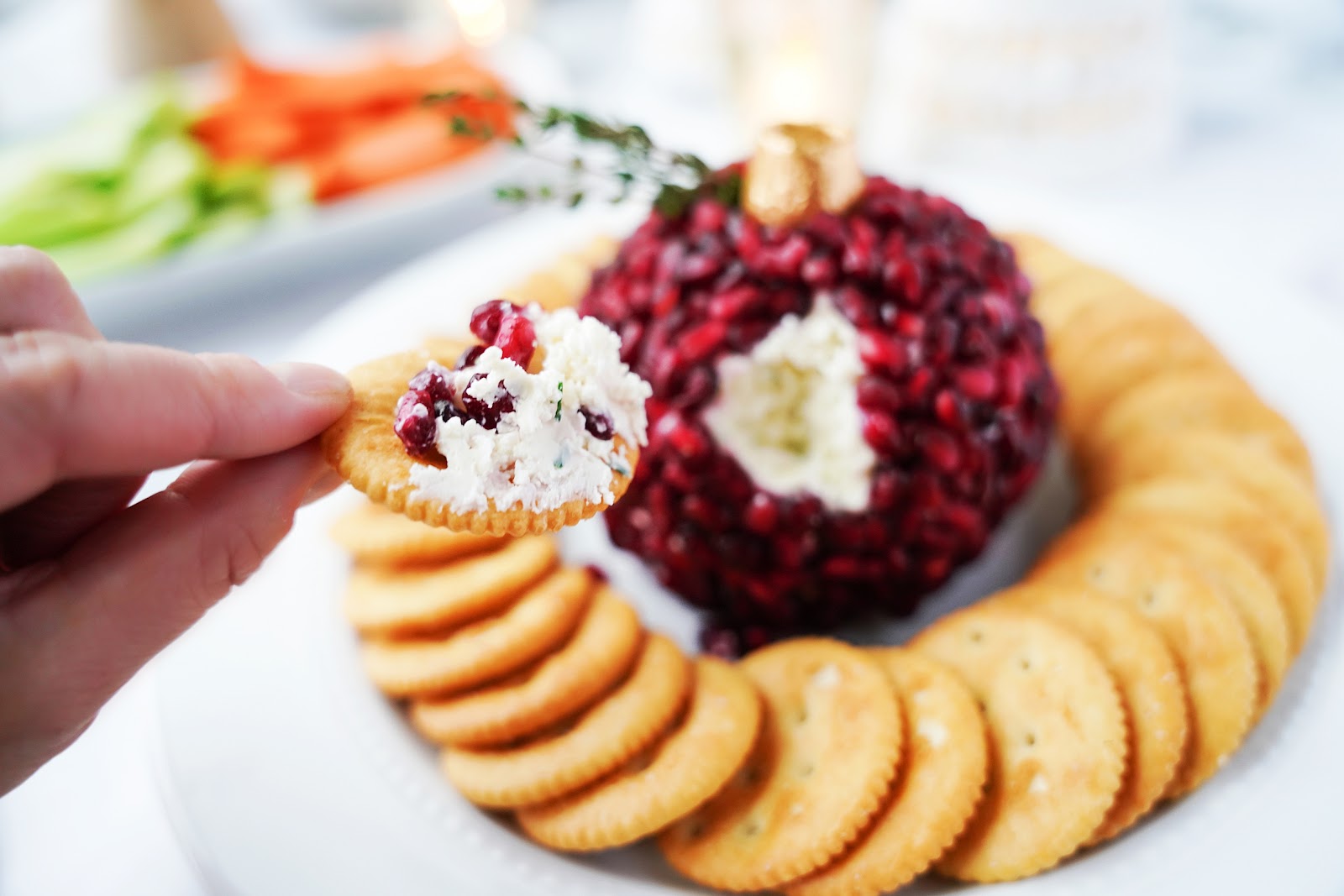 Pomegranate cheese ball on crackers.