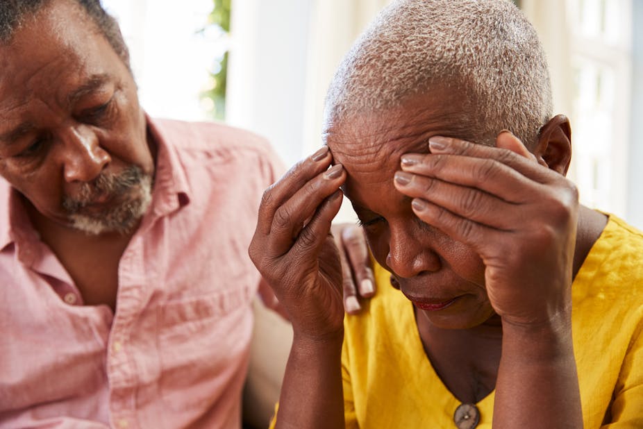 An African woman receives comforting support from a caregiver