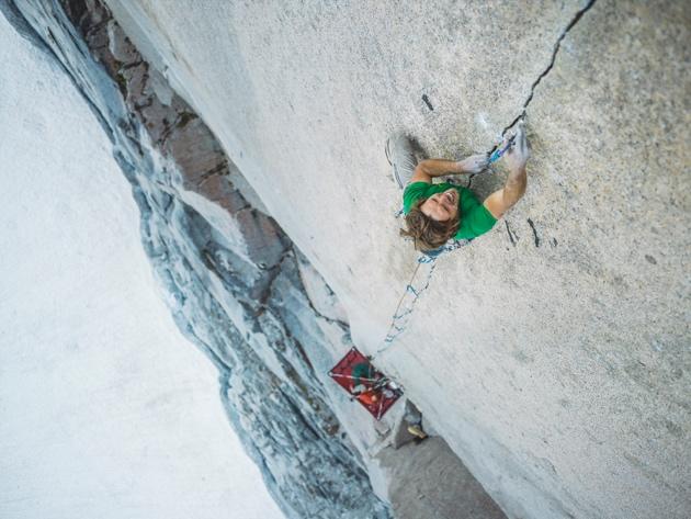 A person climbing a rock wallDescription automatically generated with medium confidence