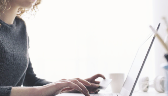 A lady typing on her laptop. 