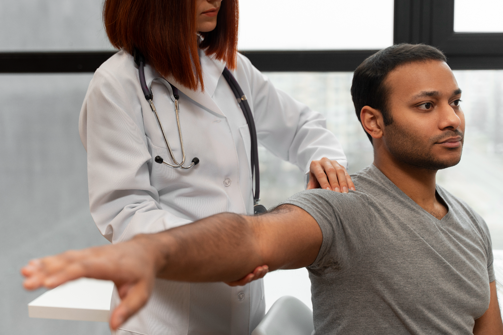 um paciente tendo sua mobilidade na região superior avaliado pelo medica 