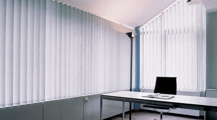 Vertical blinds controlling the amount of light in an office room