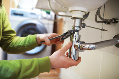 how to navigate hidden remodeling costs with design build contractors remodeler fixing sink plumbing custom built michigan