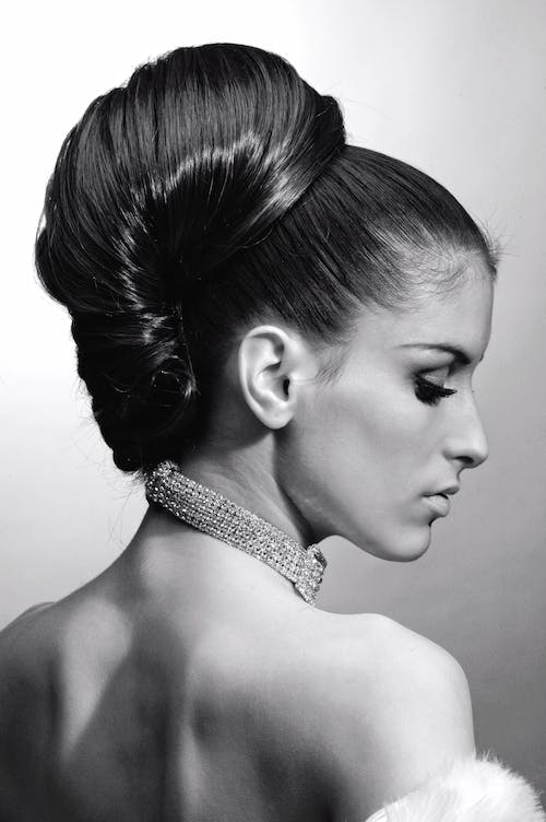 A model posing with her hair in a big, classy bun