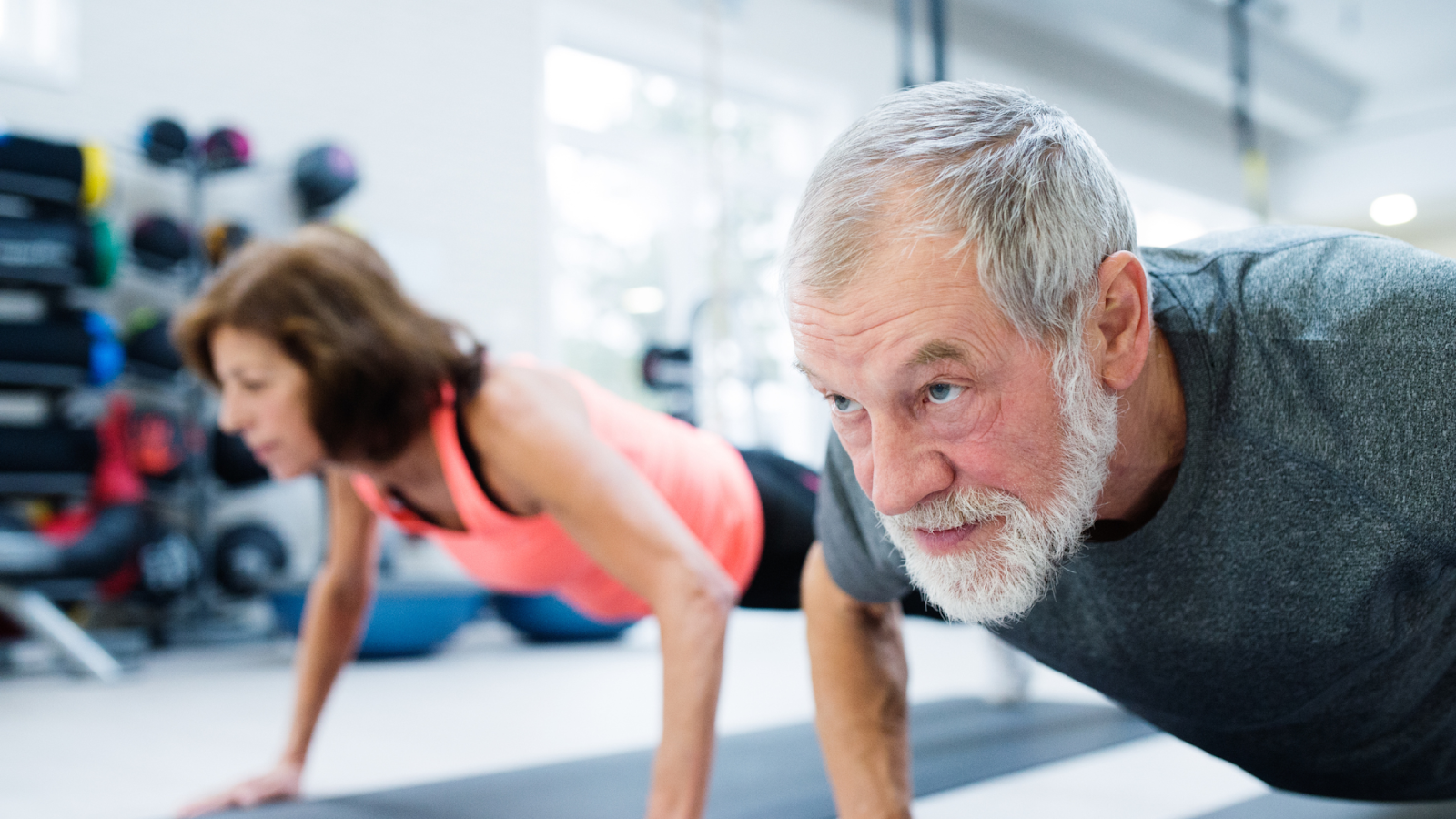 old man and old woman doing push ups
