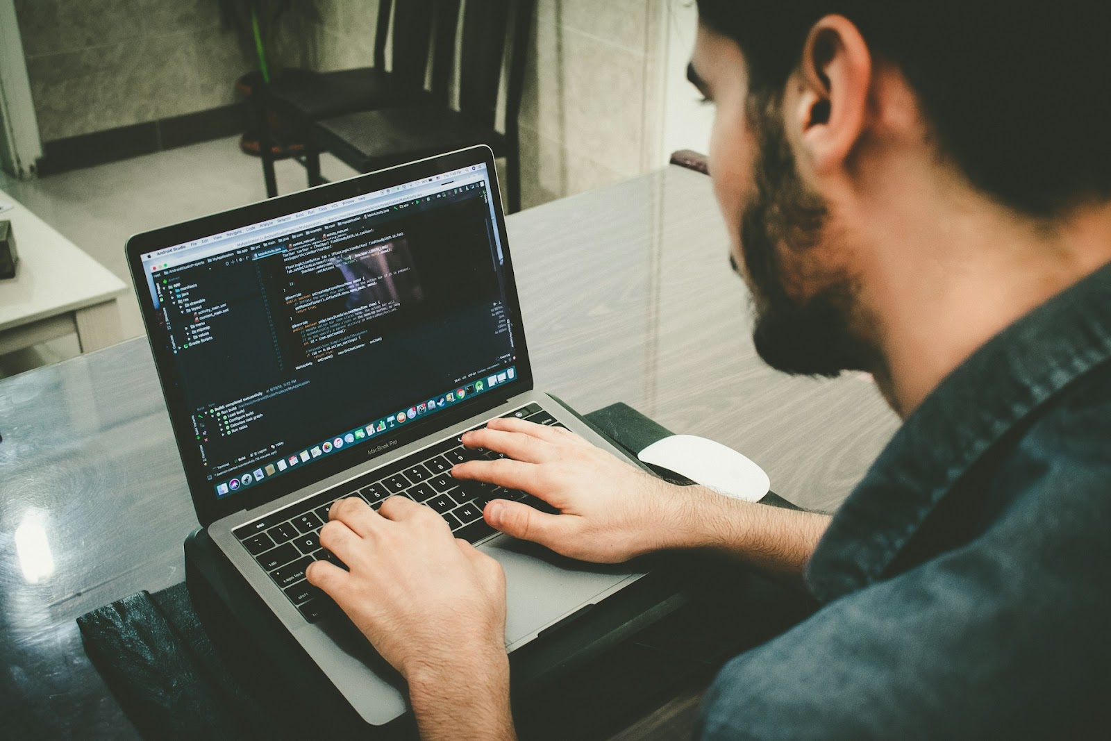 a man typing on a laptop