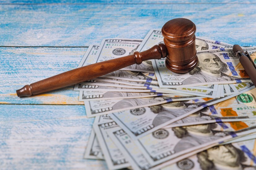 The judge's gavel, banknotes of American dollars on the business