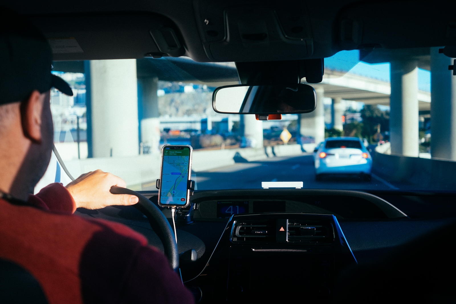 lyft driver in the front seat checking his phone