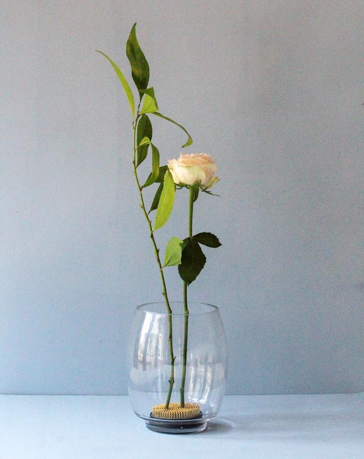 Floral design frogs placed at the bottom of a glass vase