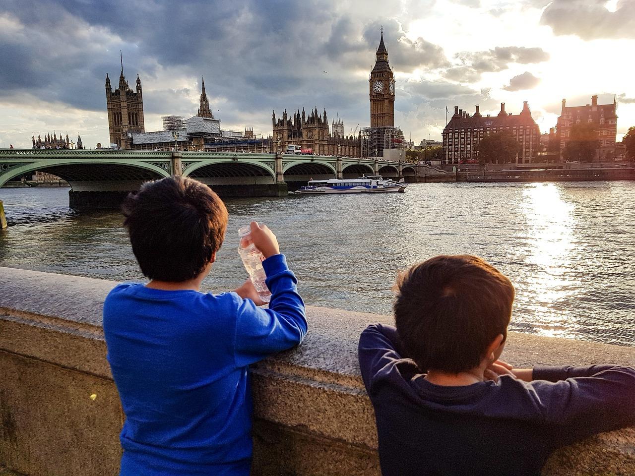 Two boys looking at a river

Description automatically generated