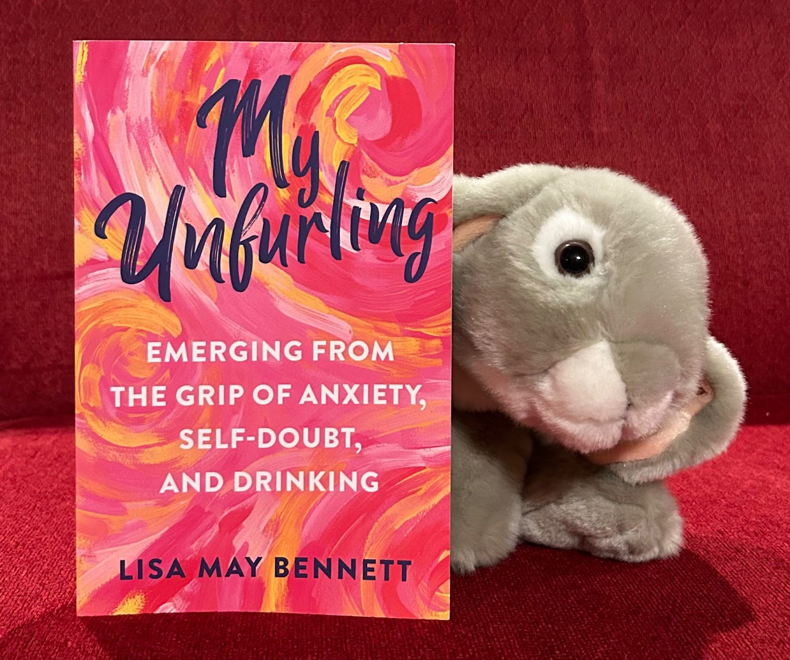 Caption: Sprinkles appreciated reading My Unfurling by Lisa May Bennett and recommends it to any adult bunny who finds the words in the title page of any interest. 