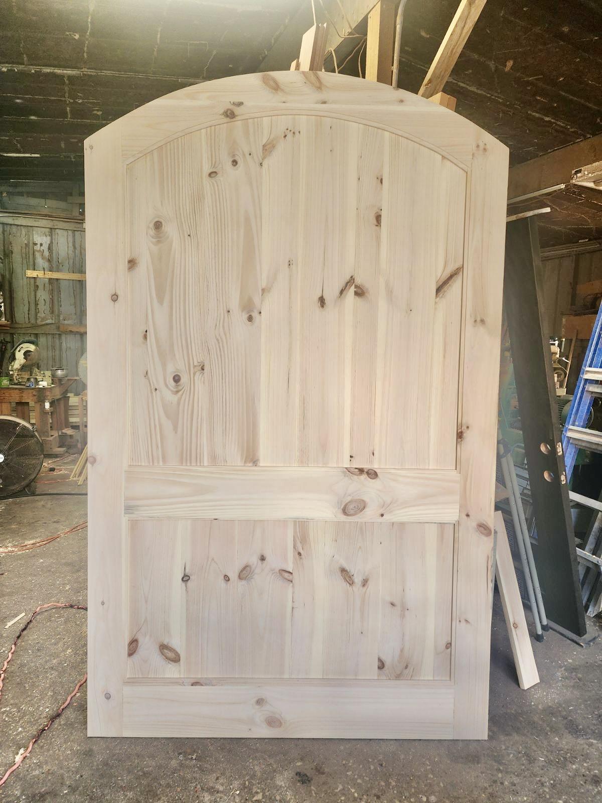 A wooden door in a shed Description automatically generated