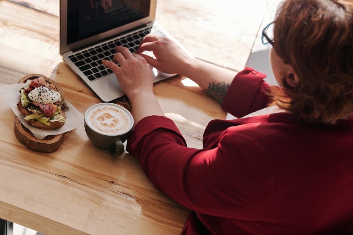 Free Woman Using MacBook Pro Stock Photo