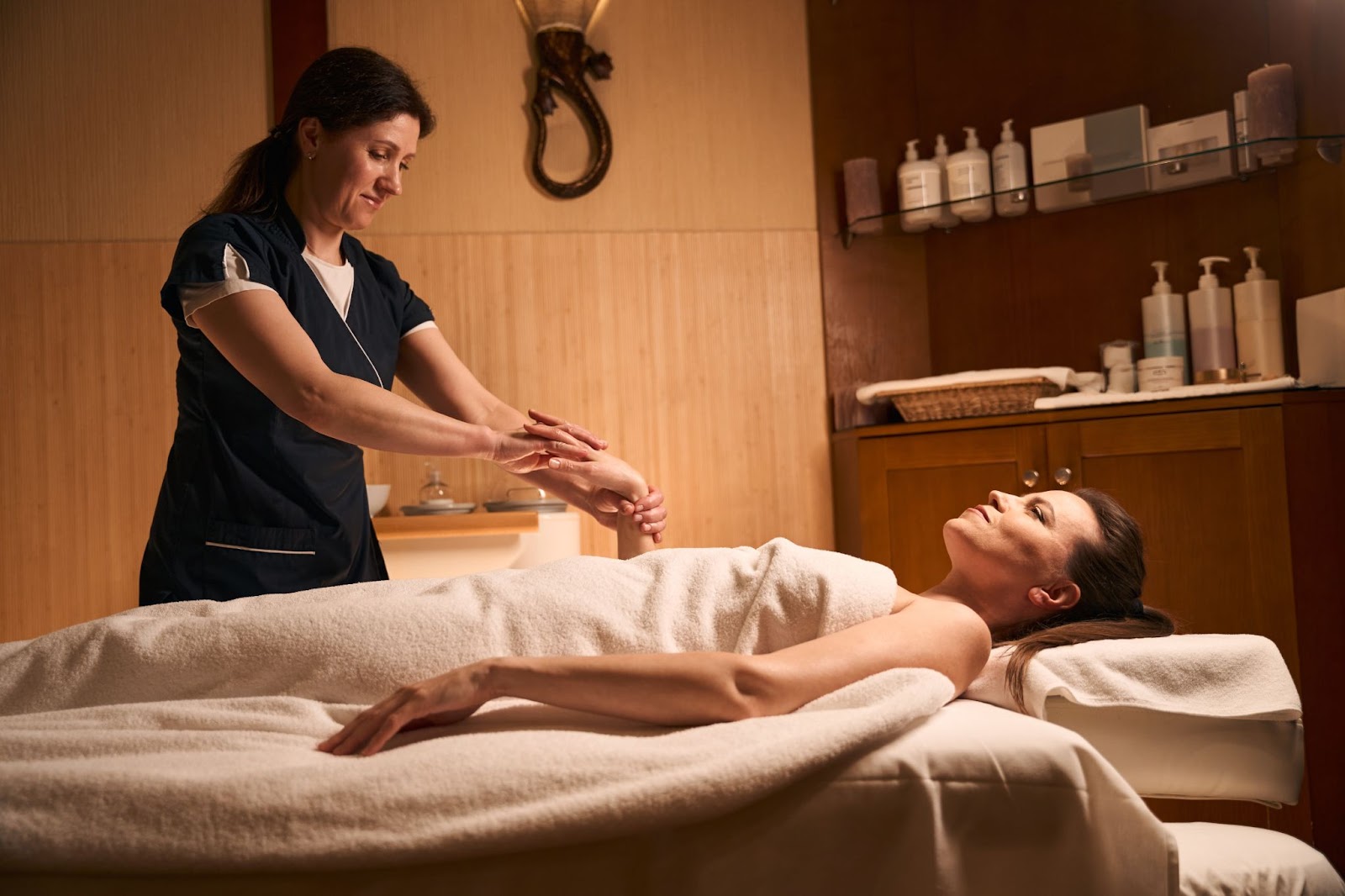 Woman receiving a relaxing massage at a spa.