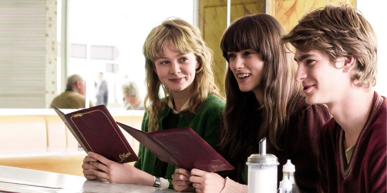 Carey Mulligan, Keira Knightly, and Andrew Garfield sit at a counter. 