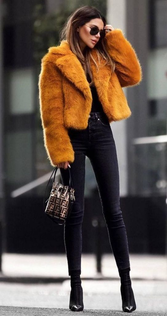 Picture of a lady rocking a faux fur and accessorizing with shades 