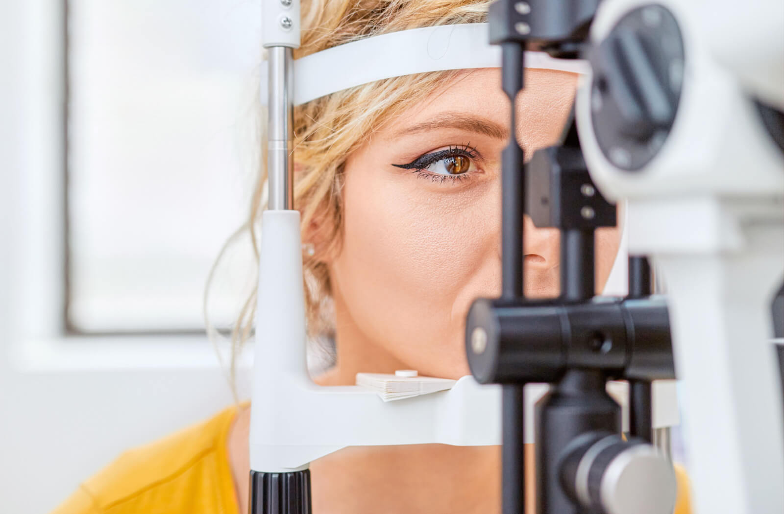 Close-up of a woman undergoing a slit-lamp exam.