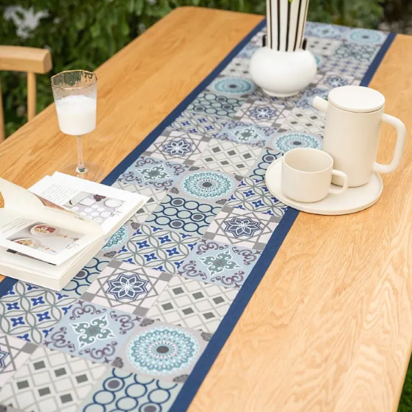 Small patterned blue table runner with intricate geometric and floral prints, and tassels