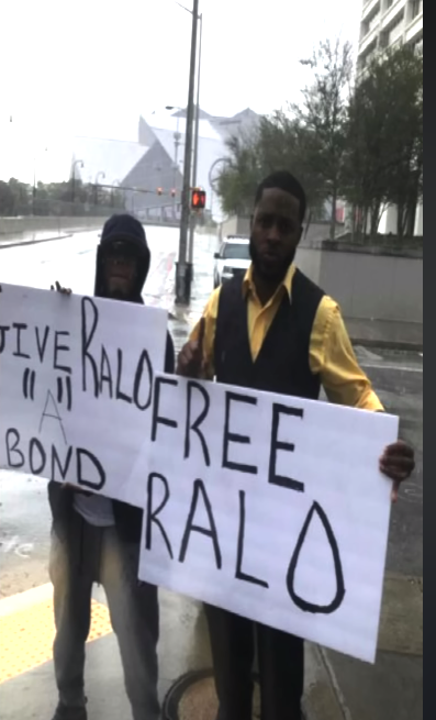 Two men holding signs on a street

Description automatically generated with low confidence