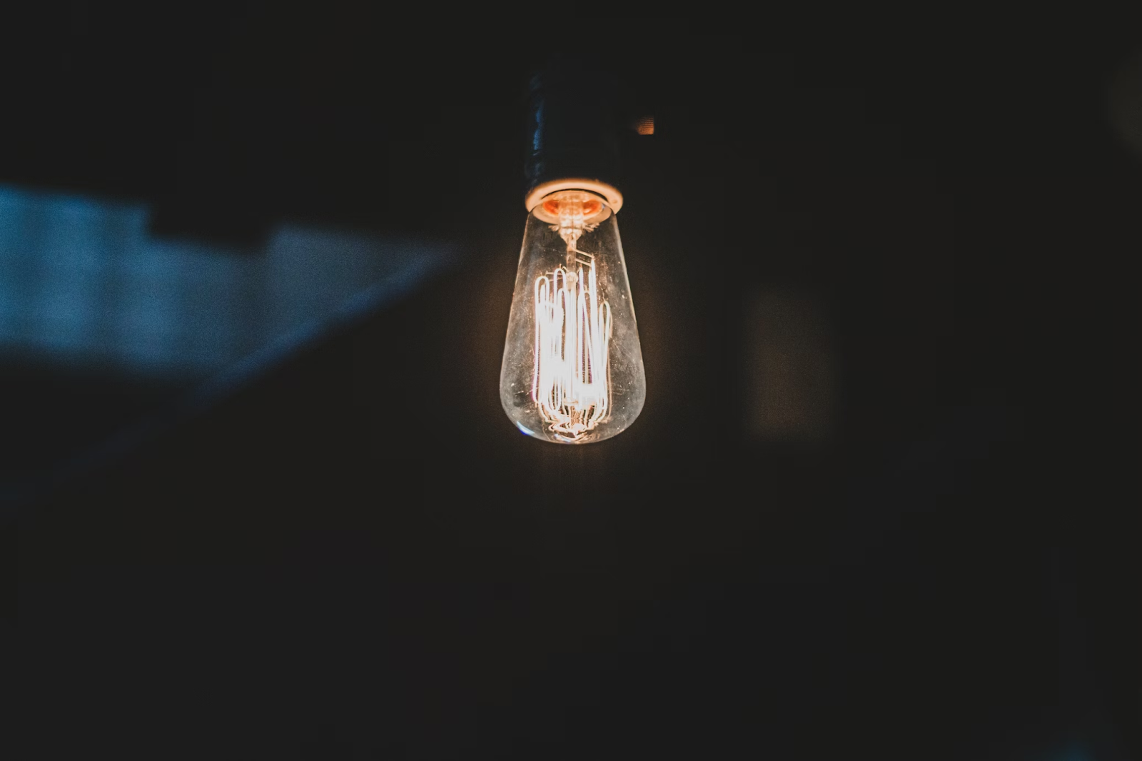 light bulb shining in dark room