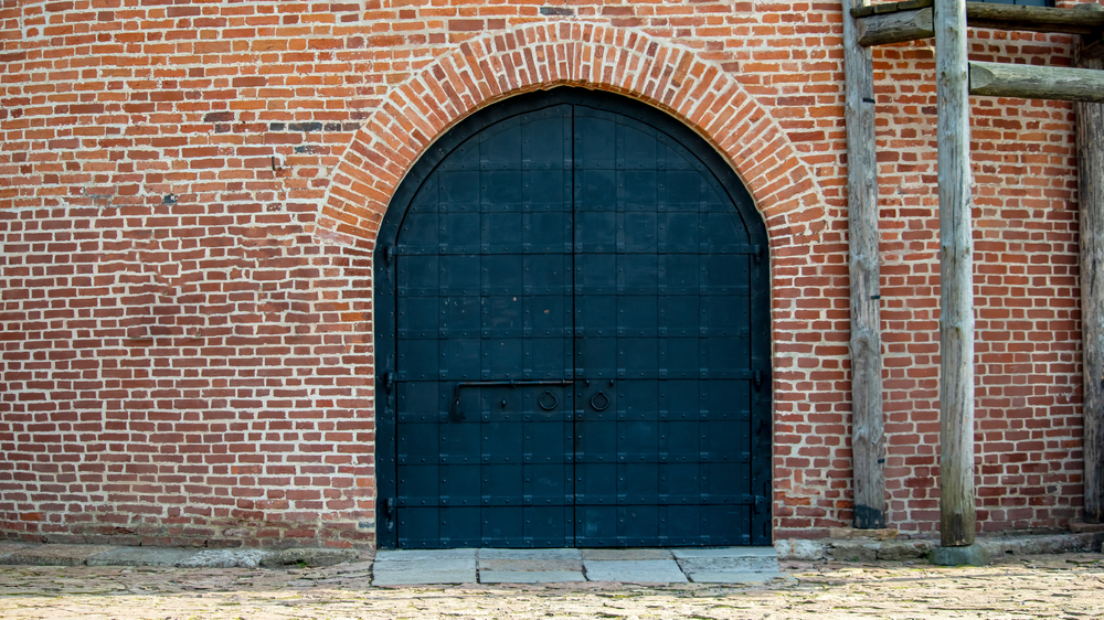 History of Iron Doors: Large Iron Door of a Medieval Defensive Brick Tower