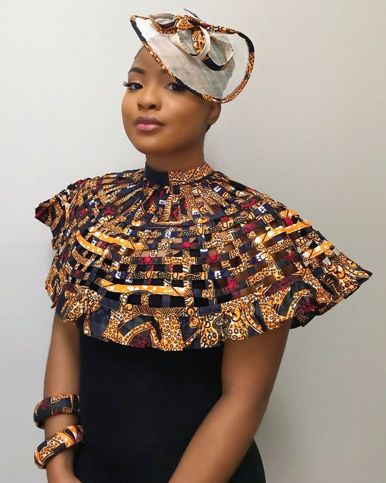 Picture of a lady rocking an African print dress with her  matching fascinator hat