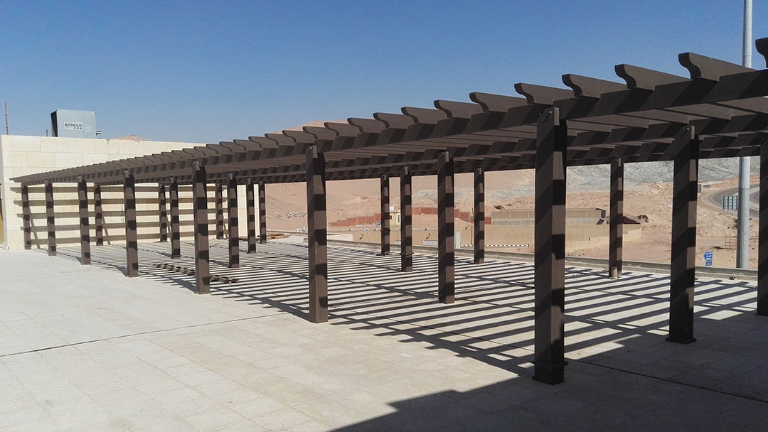 A shaded walkway featuring a composite pergola system
