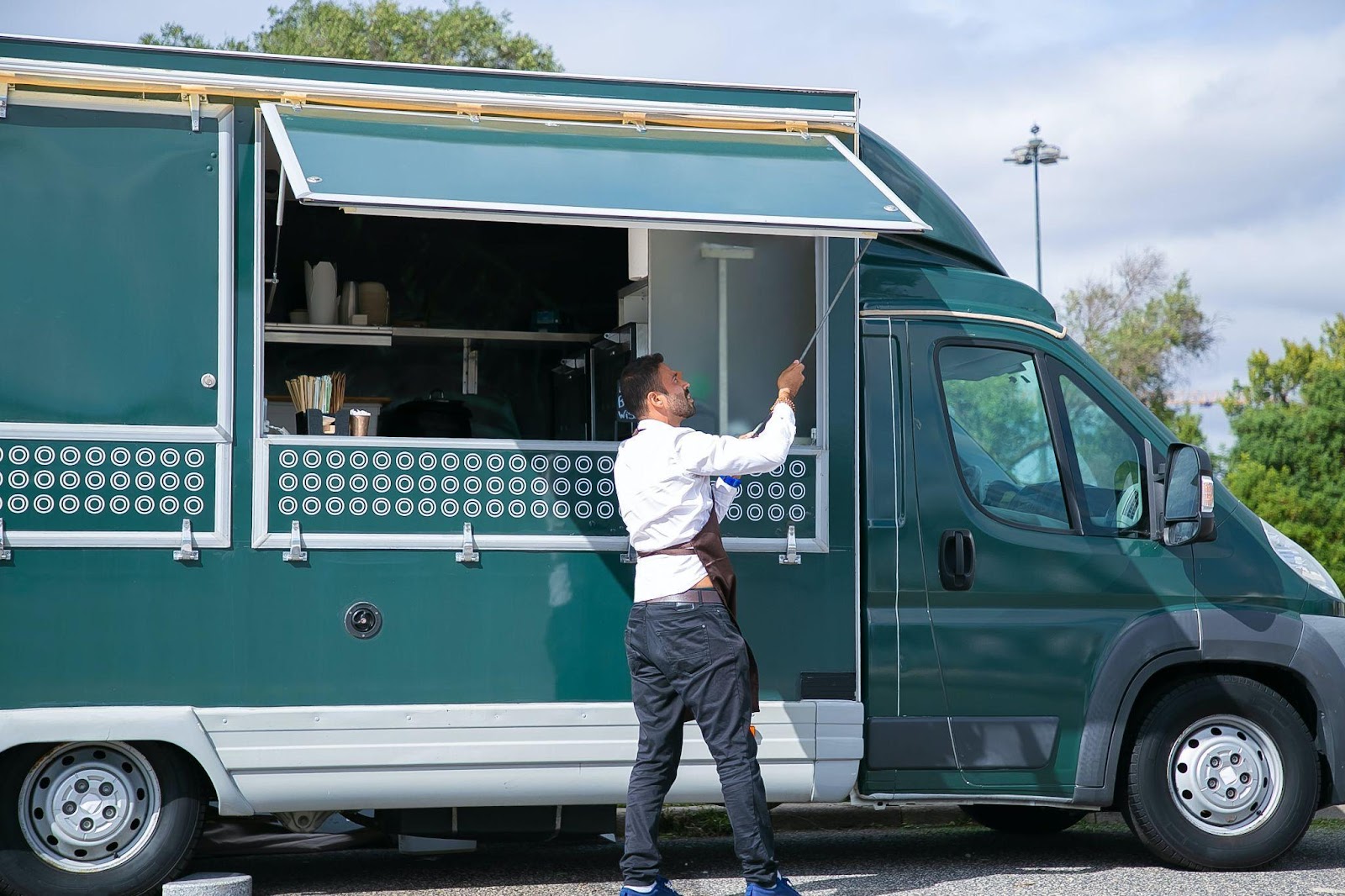 a man setting up a food truck