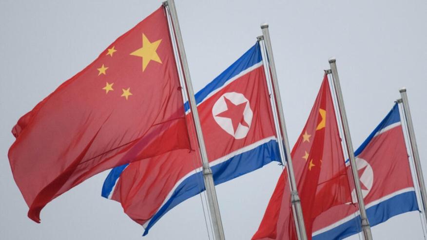 North Korean and Chinese flags fly in Pyongyang on June 19, 2019.