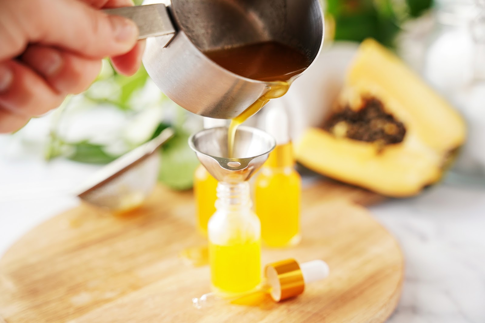 Transfer strained liquid to beauty dispensers through a funnel.