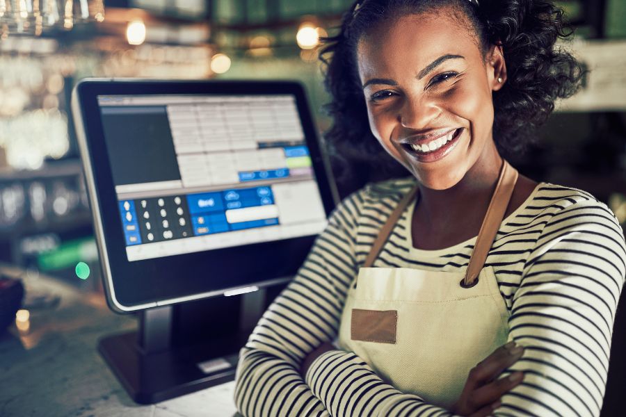 Smiling woman with a digital cash register.
