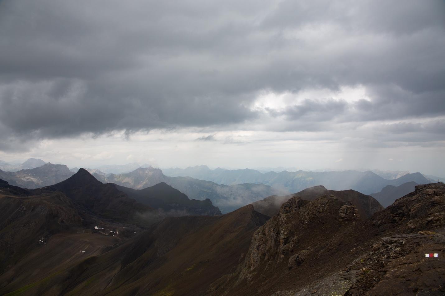 A mountain range with clouds in the sky

Description automatically generated