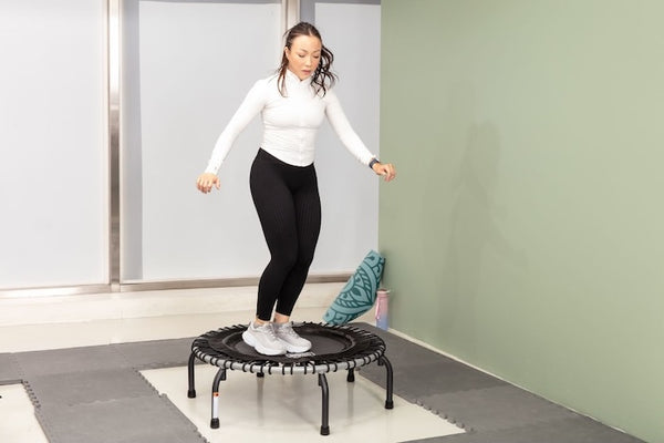 A woman on a rebounder trampoline.