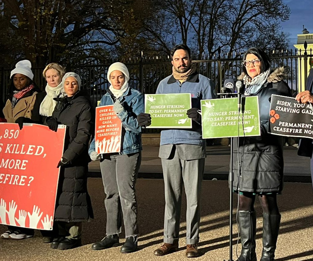 Image of Rashida speaking alongside state reps holding signs outside the White House