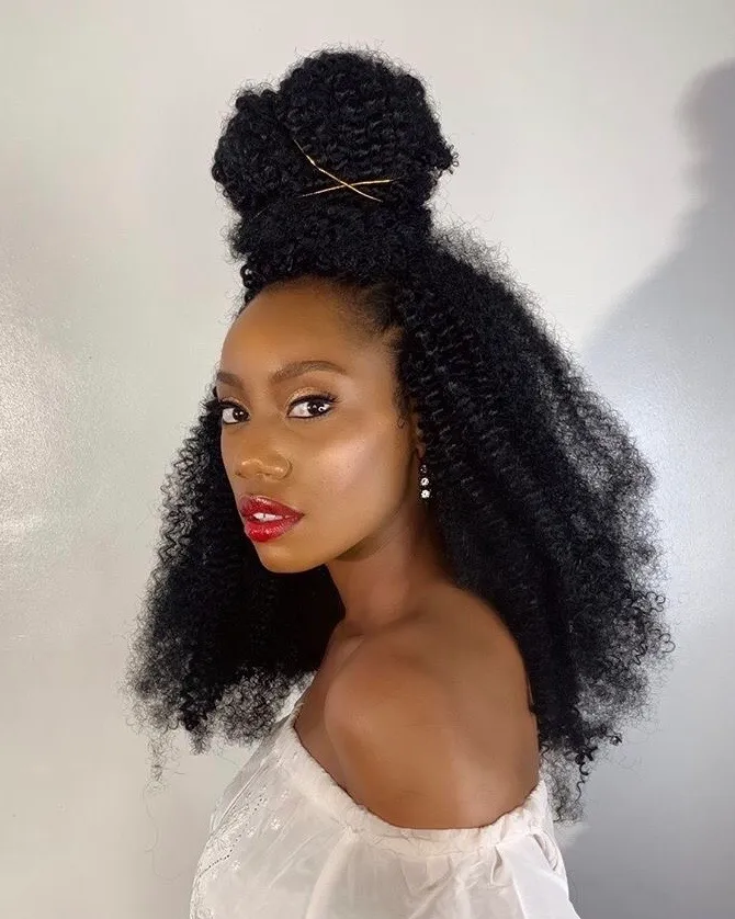 Side view of a  lady rocking her crochet weave in a half up half down style