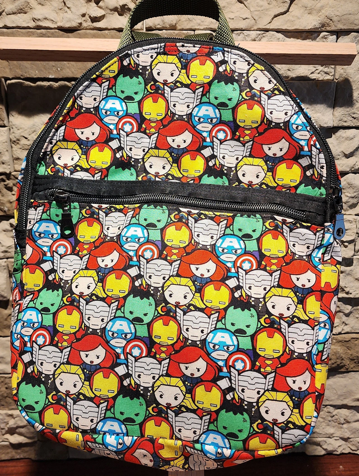 A backpack showing chibi versions of several Marvel superheroes such as Thor, Iron Man, the Hulk and so on