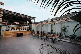 A patio with tables and chairs

Description automatically generated with low confidence