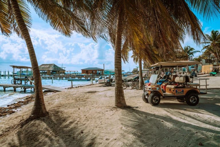 Belize travel guide golf cart on the beach Ambergris Caye.