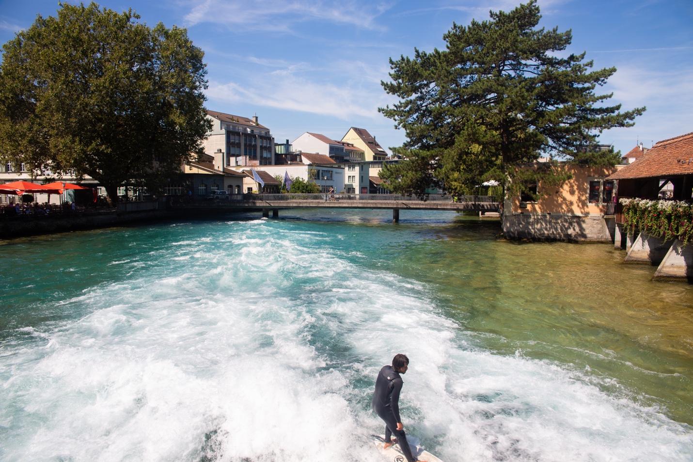 A person surfing on a river

Description automatically generated