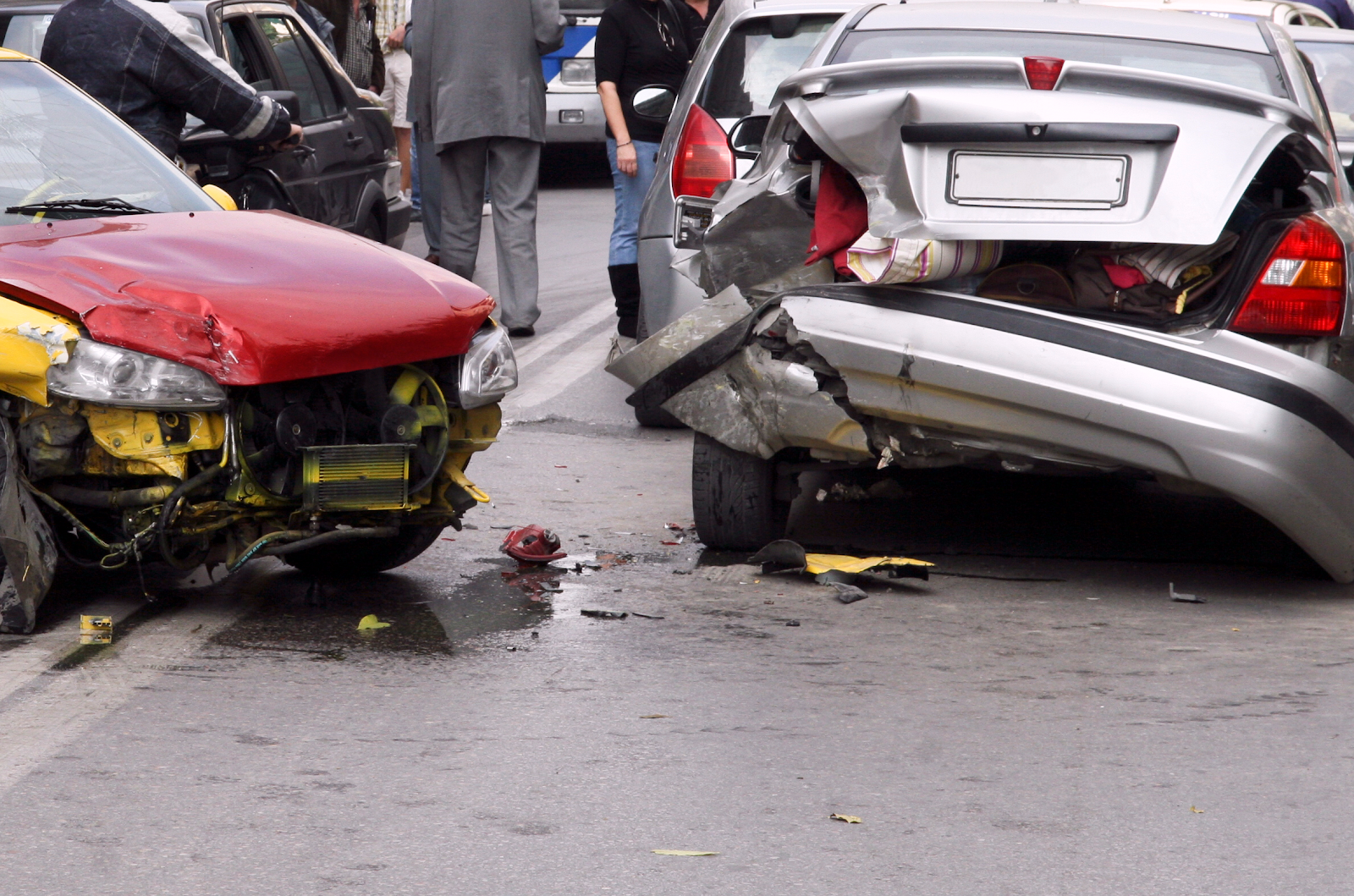 liability insurance theme: people in a car accident, red car and silver car damaged 