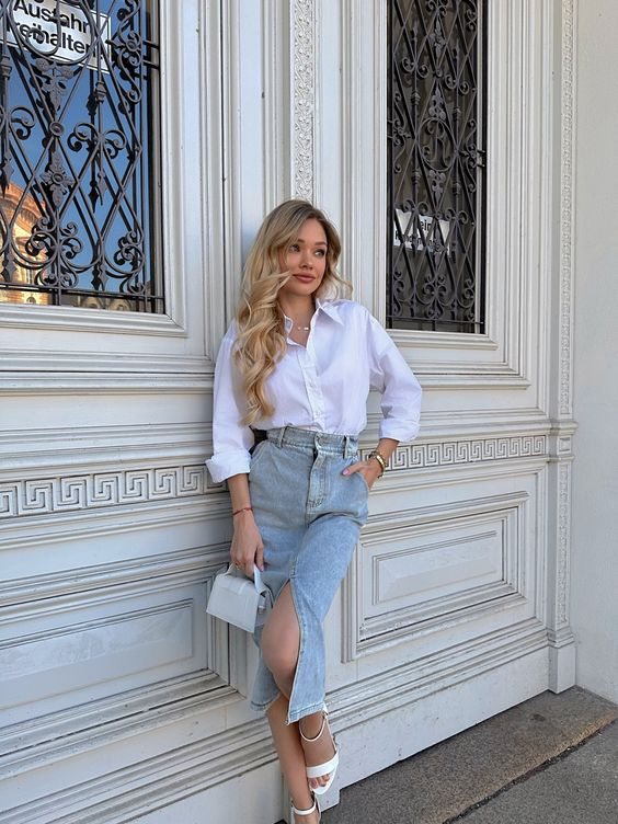 Picture of a lady rocking the long denim skirt with crisp  white shirt