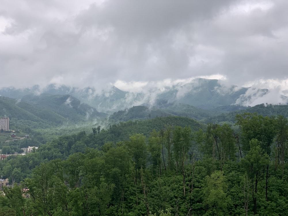 a view of a mountain range with clouds in the sky