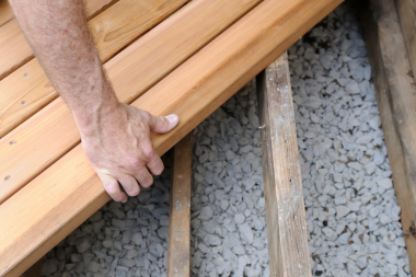 reasons to hire an experienced deck installer contractor installing decking boards custom built michigan