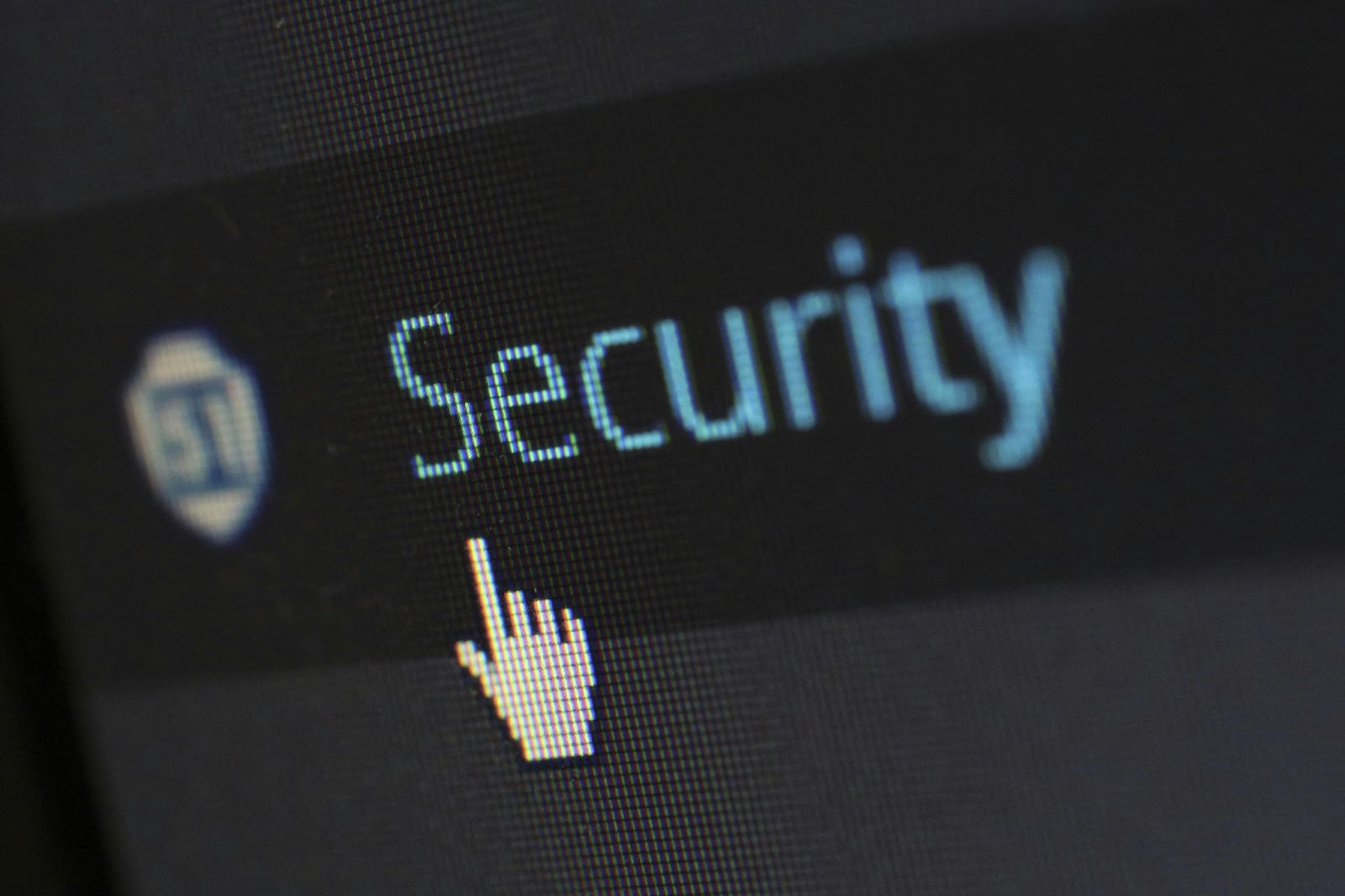 A close-up of a computer with a cursor icon next to the word "Security."