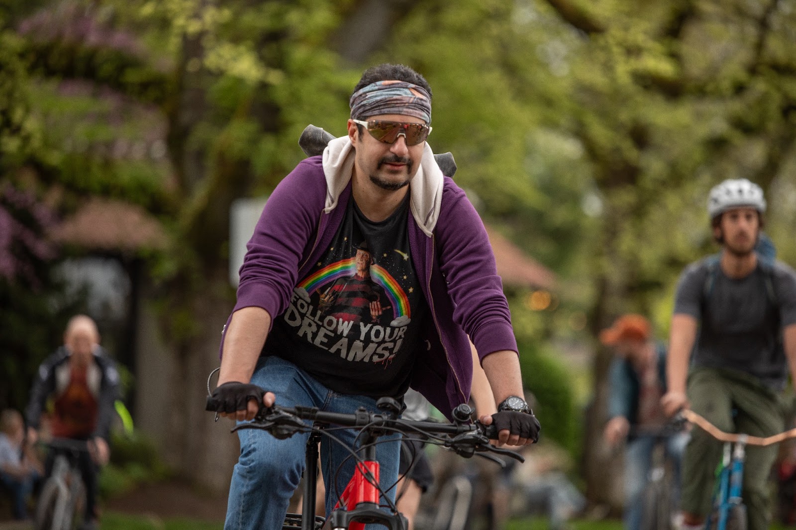 A man on a bike wearing a Freddy Krueger "Follow Your Dreams" t-shirt at the Ladd's 500 relay in Portland in April of 2024.
