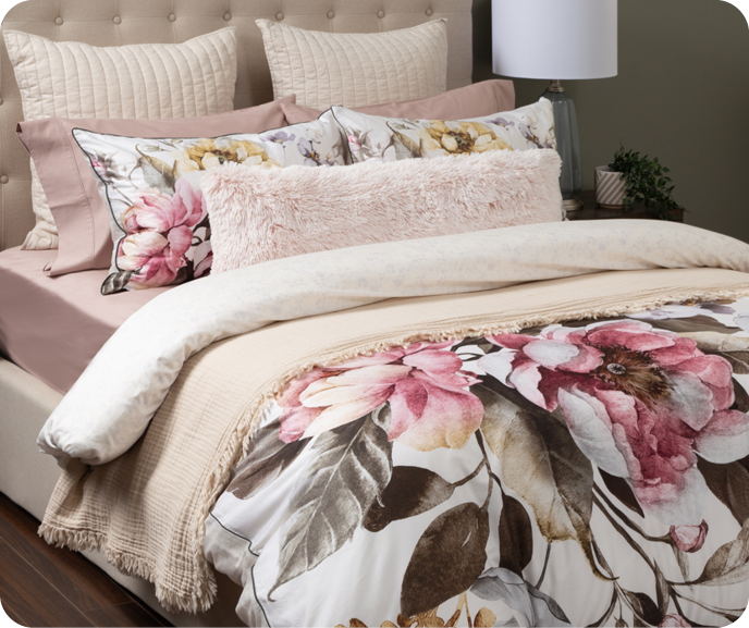 Our Botanical Braganza Duvet Cover shown on a bed styled with our Muslin Gauze Blanket in Natural.