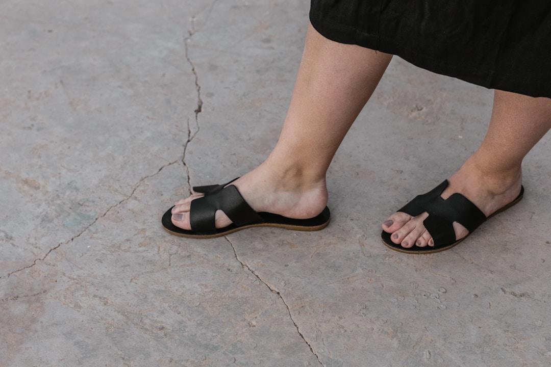 a person's feet in sandals