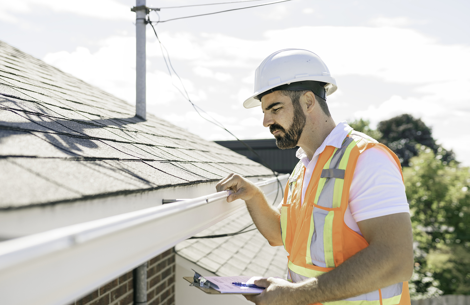 Man performing Wisconsin roof inspection