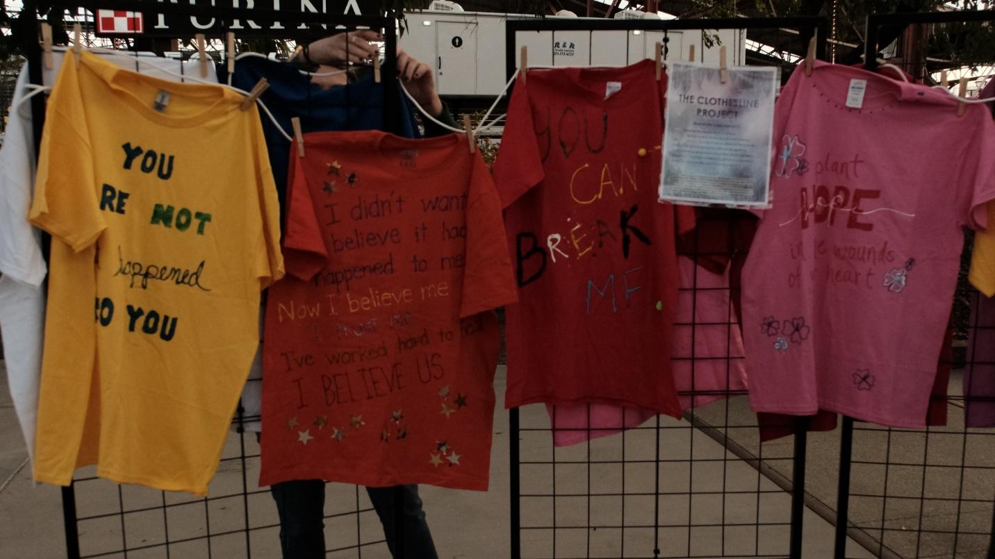 A group of t-shirts on a wire rack

Description automatically generated